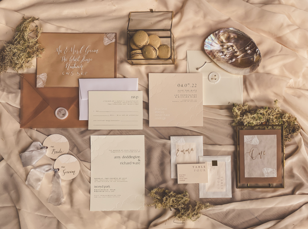 Flatlay of Wedding Stationery suite design and created by TLPS including; Wedding invitation, save the date, envelope and on the day stationery